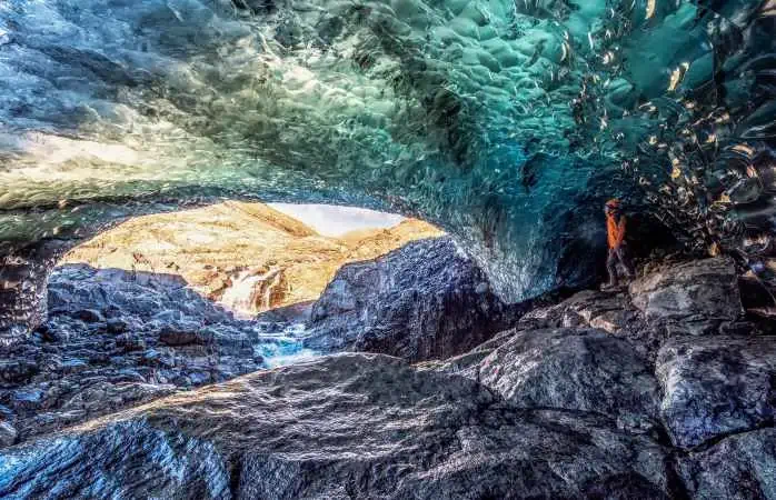 Vatnajokull glacier, Eastern Iceland, Iceland, Northern Europe. Man standing in a crystal ice cave in winter