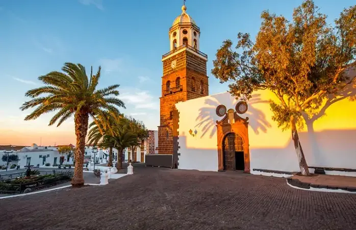 Central square with old church Nuestra Senora de Guadalupe in Teguise village on the sunset on lanzarote island